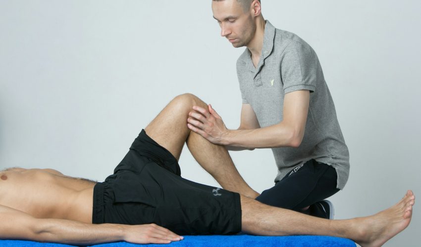 a man getting his leg examined by a doctor